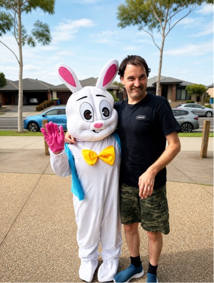 A participant with his arm around the Easter Bunny at a Newdawn community event.