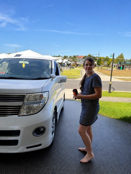 A participant beside the van, about to head out for the day.