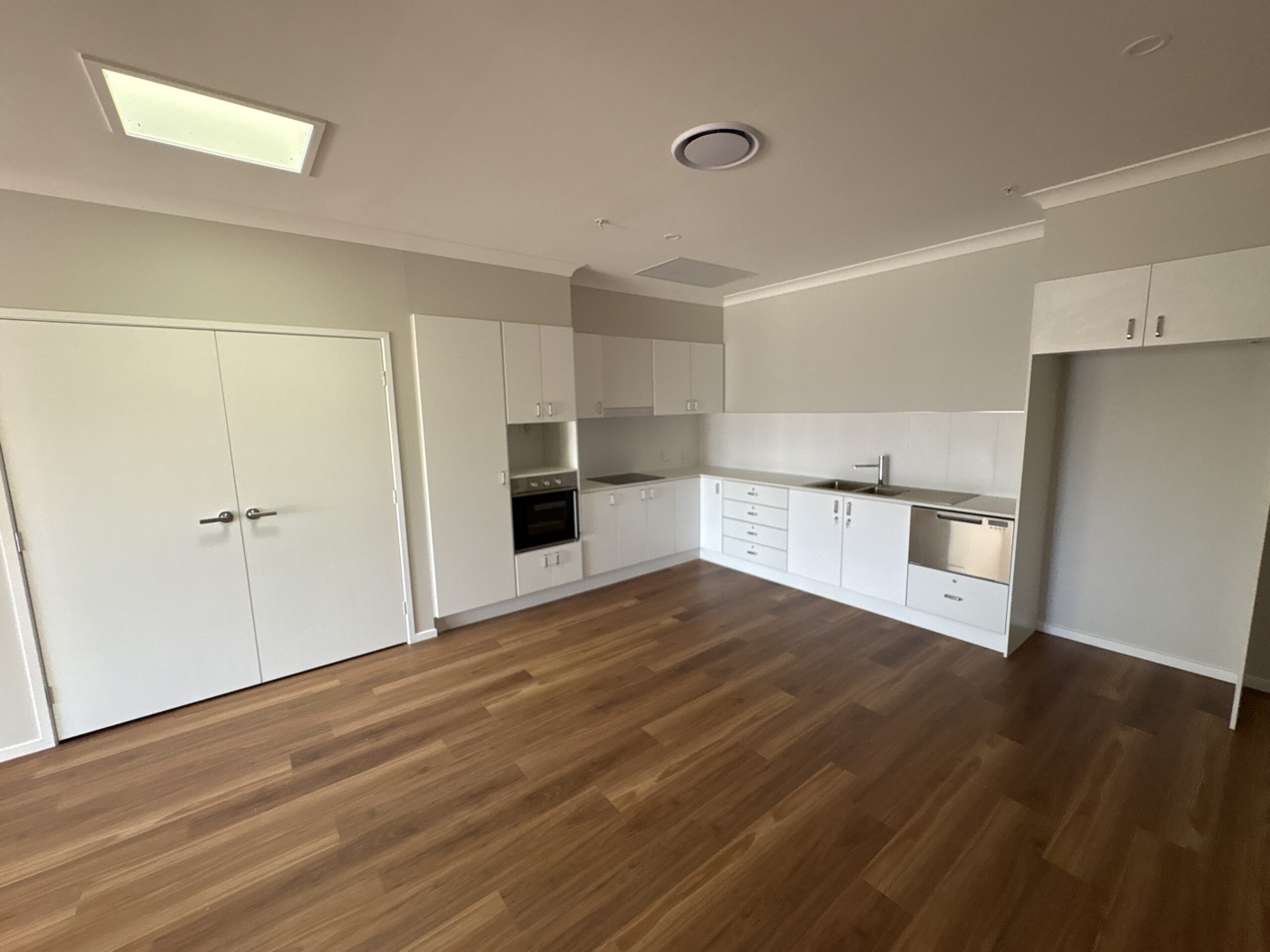 Open-plan kitchen and dining with timber flooring