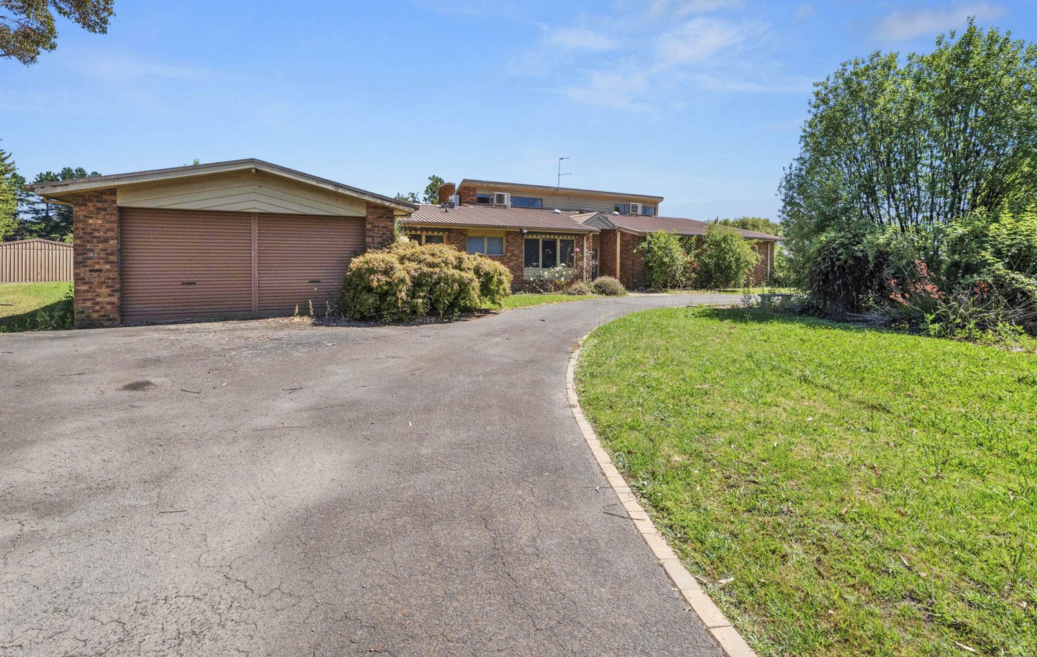 Front of the Traralgon home with brick facade, garden and double garage